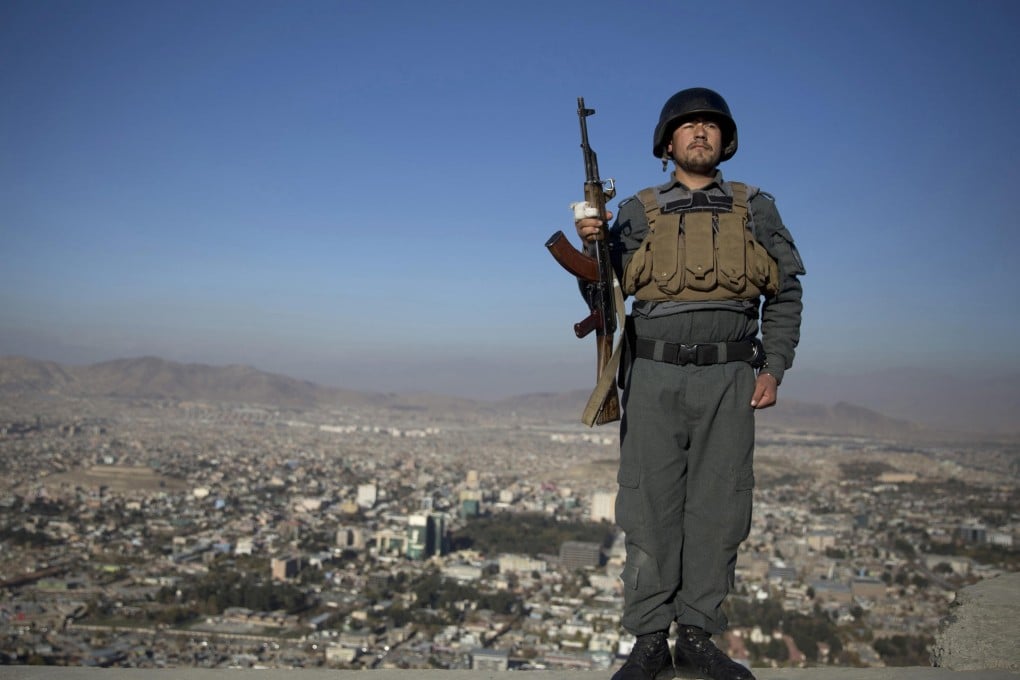 An Afghan policeman stands at a checkpoint overlooking Kabul before the security debate. Photo: AP