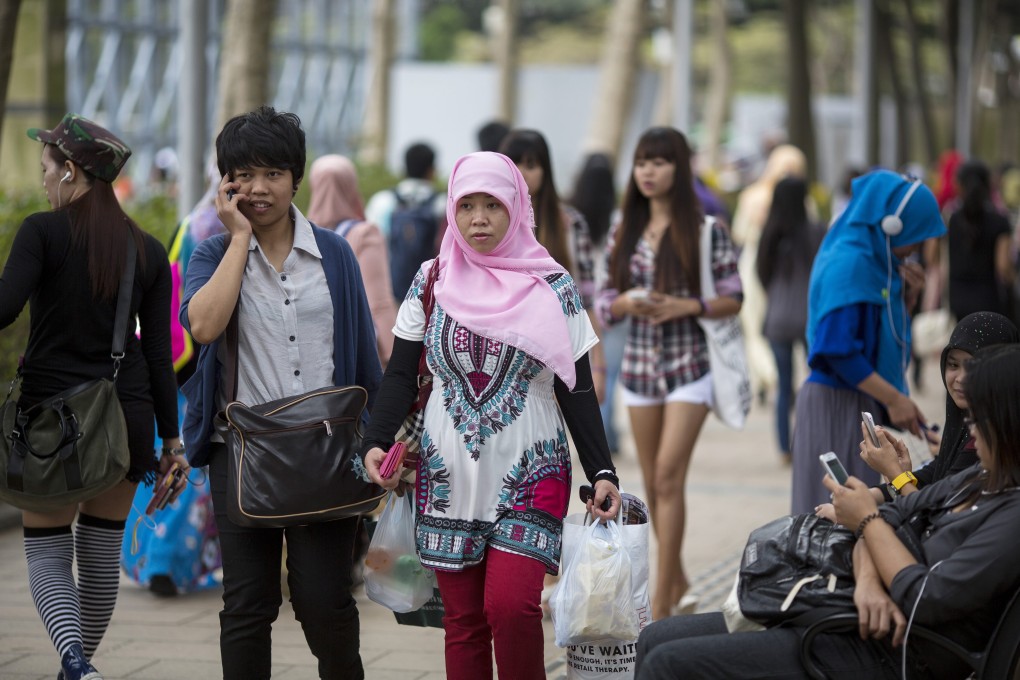 Migrant workers gather in Victoria Park during their day off in Hong Kong. Photo: EPA