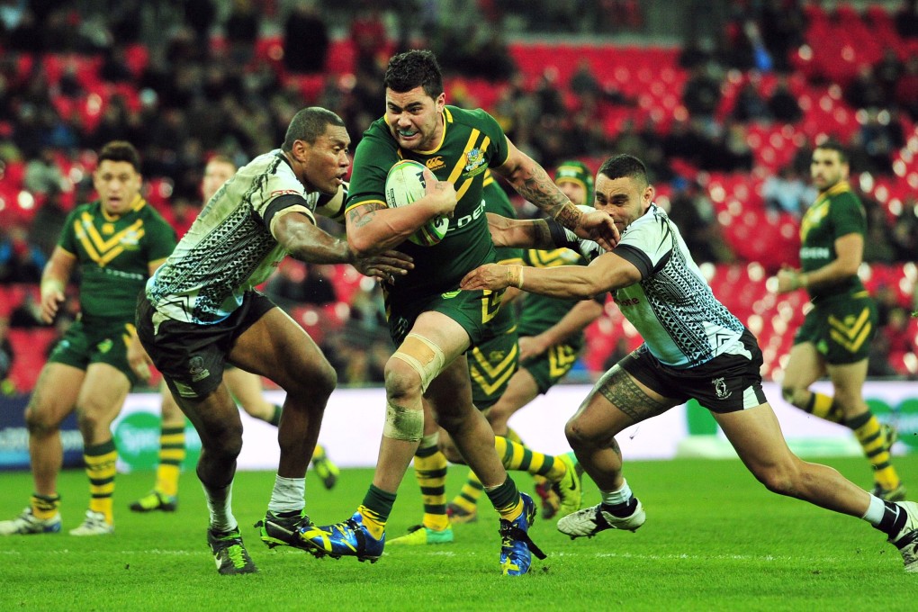 Australia's Andrew Fifita powers through to score their 11th try during their semi-final against Fiji. Photo: AFP