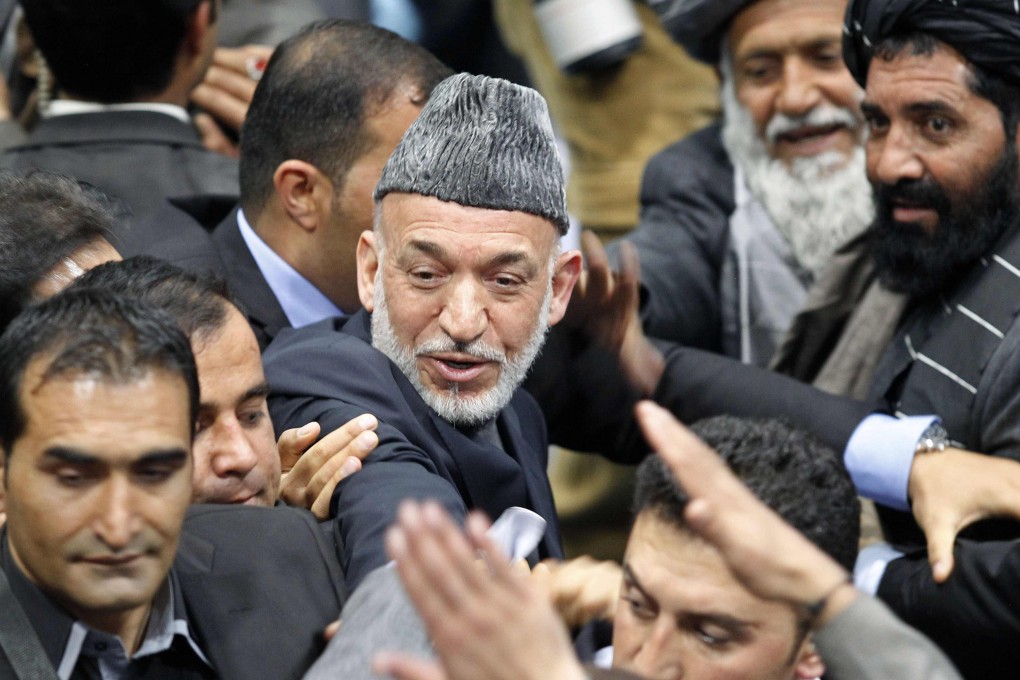 Afghan President Hamid Karzai leaves the Loya Jirga in Kabul on Sunday. Photo: