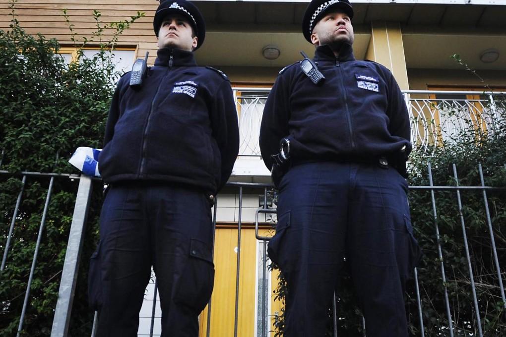 Police guard a flat where the women were held. Photo: EPA