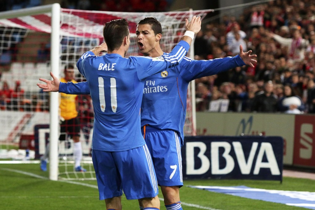 Cristiano Ronaldo celebrates with Gareth Bale after scoring the first goal in Real Madrid's 5-0 demolition of Almeria. Ronaldo later went off with a thigh injury. Photo: EPA