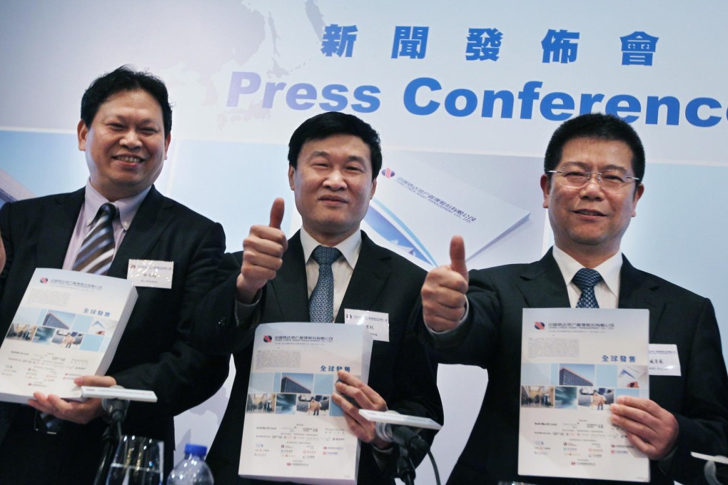 Cinda Asset executives Xu Zhichao, Hou Jianhang, and Zang Jingfan at the IPO launch. Photo: Nora Tam
