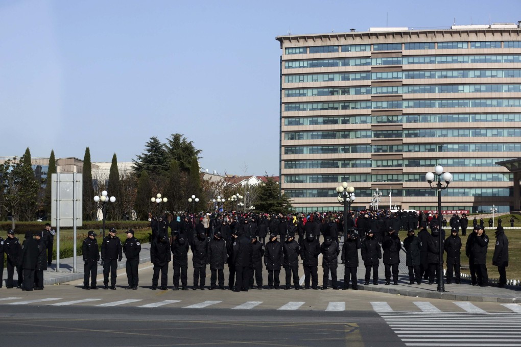 Police line up outside local government offices in Huangdao. Photo: Reuters