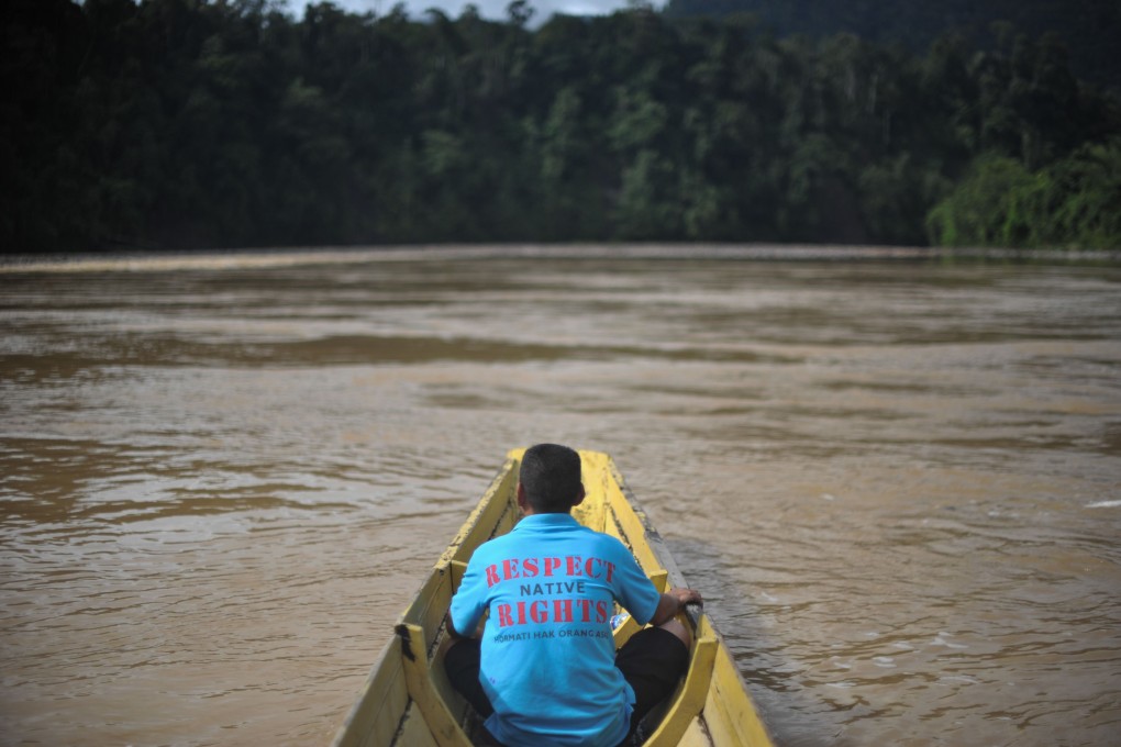 A villager sits on a boat near the proposed dam on the Baram River in Borneo's Sarawak state. Photo: AFP