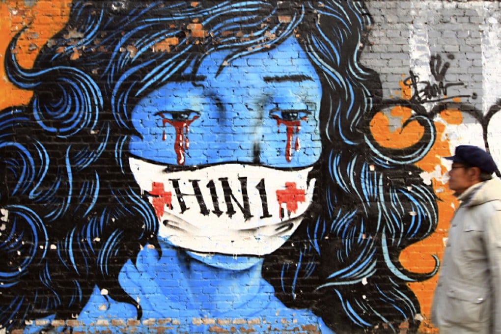 A man walks past a graffiti on a wall featuring a crying woman wearing a mask marked with H1N1 in Beijing in 2009. Photo: AP