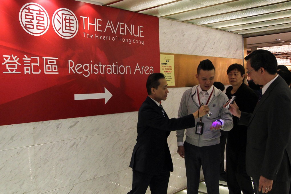 Potential buyers wait at Hopewell Centre for a chance to snap up units of Sino Land and Hopewell's The Avenue in Wan Chai. Photo: Sam Tsang