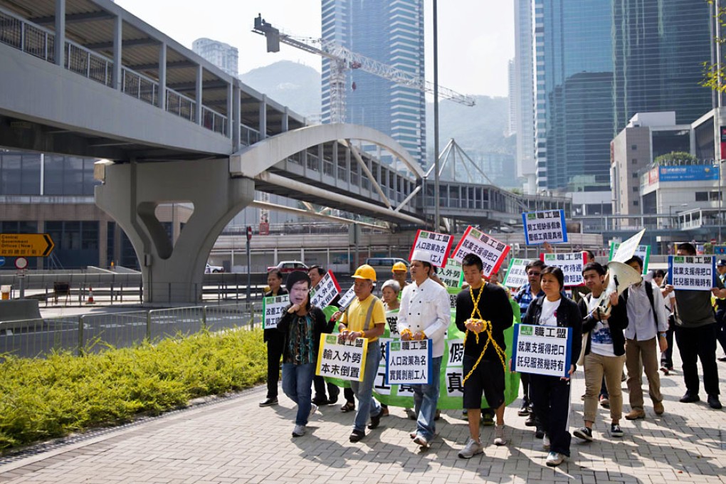Protesters walk towards the central government offices for a rally calling for the protection of local labour rights. The government has said it could back an influx of foreign workers to solve the labour shortage problem due to an aging population. Photo: AFP