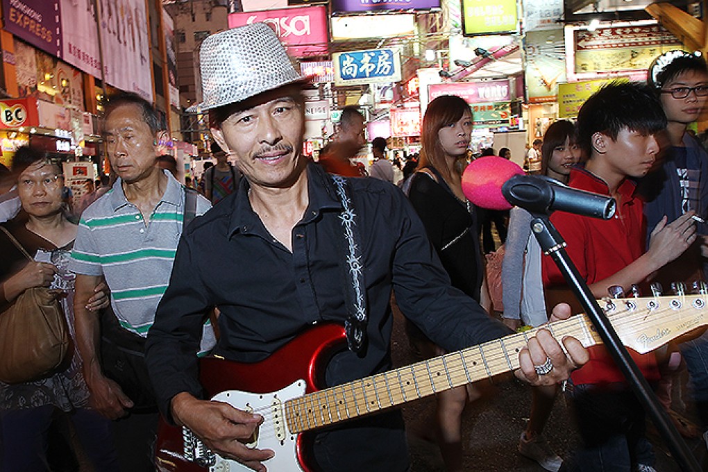 Lam Fat, lead singer of the band 3L, performs on Sai Yeung Choi Street South. Photo: Sam Tsang