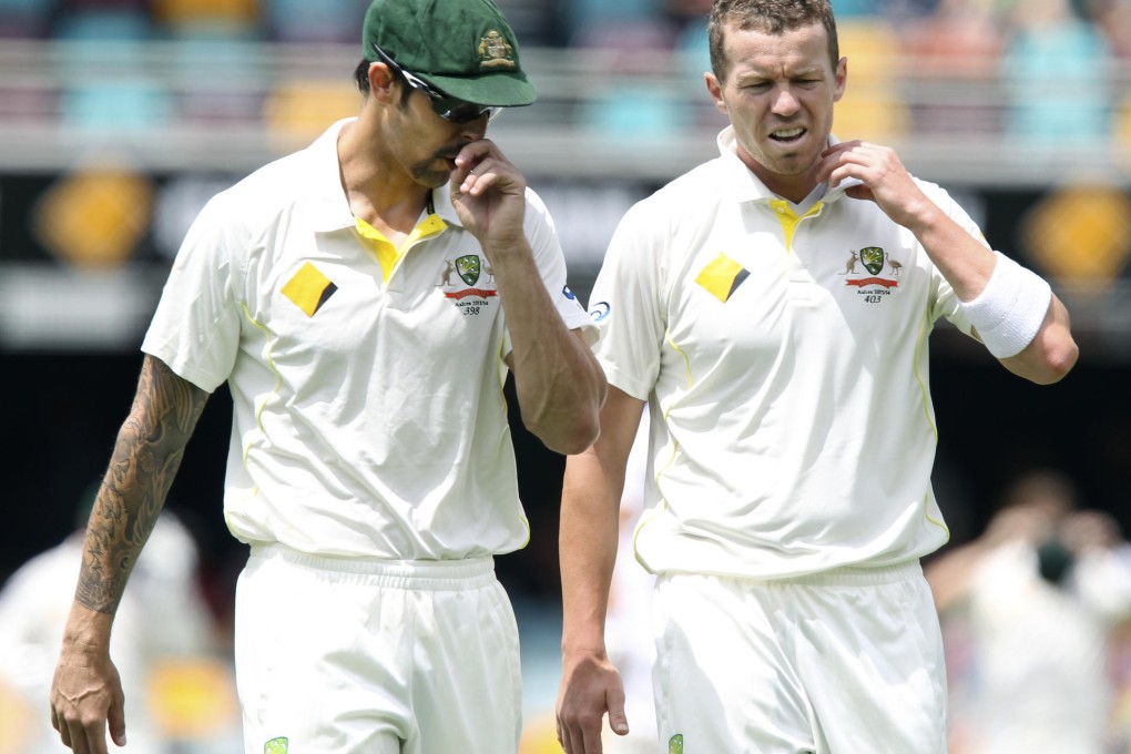 Australian fast bowlers Mitchell Johnson (left) and Peter Siddle discuss tactics for the second Ashes tes. Photo: AP
