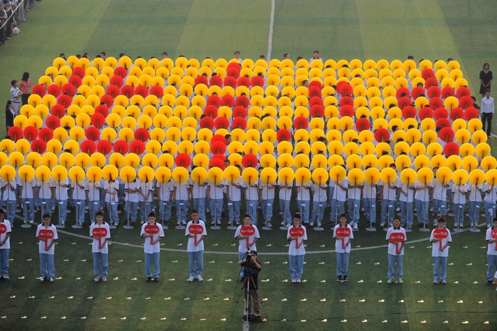 Pupils make a formation with flowers spelling out their school's name to welcome new classmates at a ceremony at Beijing No. Eight Middle School, one of the most elite in the city. Photo: China Foto Press