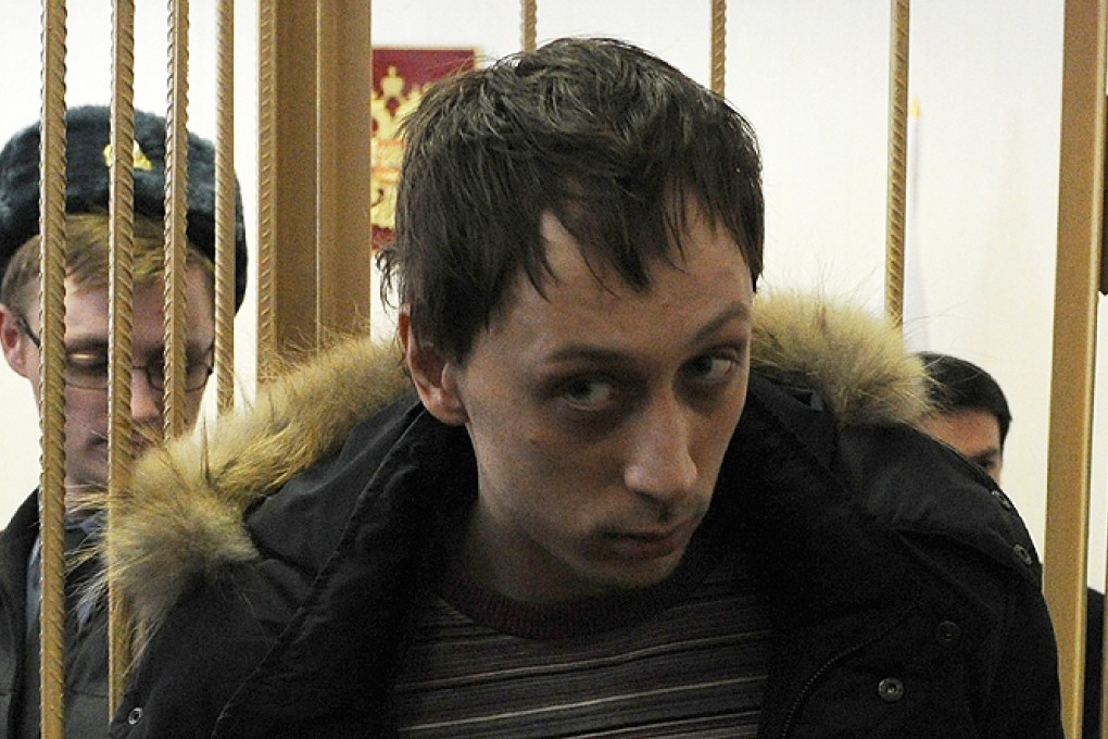 Pavel Dmitrichenko, a leading dancer at Russia’s Bolshoi ballet, looks on from the defendant's cage during a court hearing in Moscow. Photo: AFP