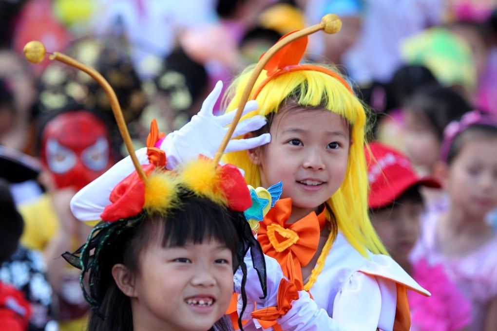 Pupils of Zhongguancun No. 1 Primary School watch performances during an art festival in Beijing on May 30, 2013.  Photo: Xinhua