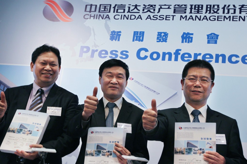 Cinda Asset executives Xu Zhichao, Hou Jianhang, and Zang Jingfan at the IPO launch. Photo: Nora Tam