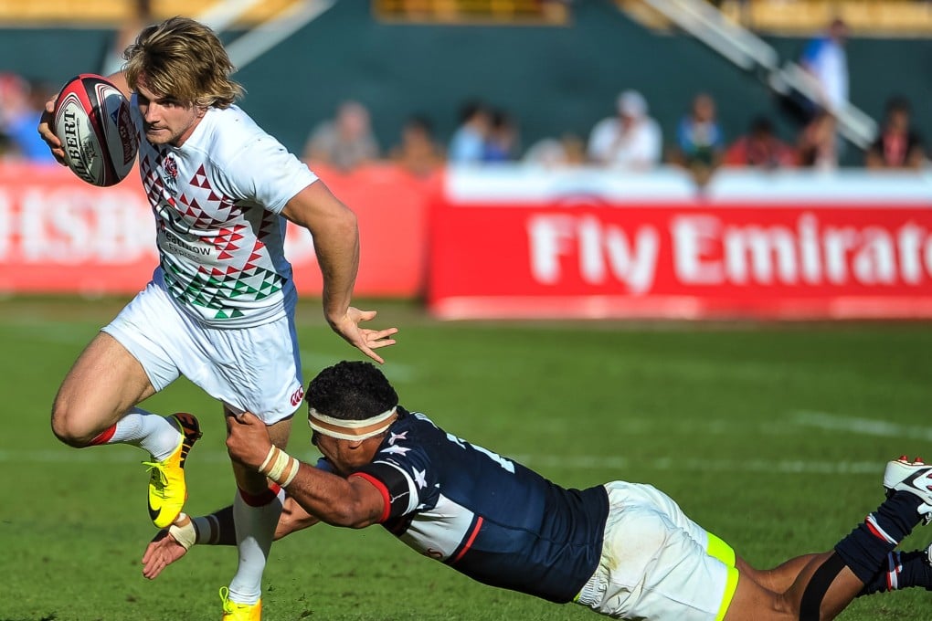 England's Sam Edgerley evades a tackle from Folau Niua of the USA during Friday's first day of action at the Dubai Sevens. Photo: AP