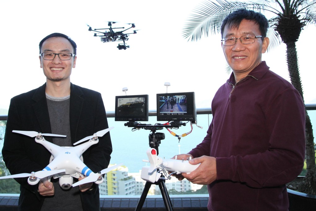 DJI Innovations founder Frank Wang Tao (left) shows off his products with his mentor Professor Li Zexiang. Photo: SCMP