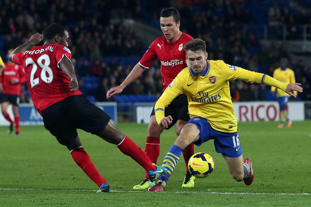 Cardiff's Kevin Theophile-Catherine (left) tries to halt the progress of Arsenal's Aaron Ramsey during their Premier League match at Cardiff. Photo: EPA