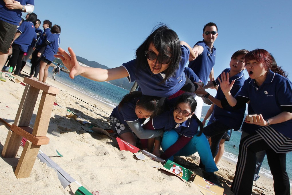 Having fun and building team spirit, the Li &amp; Fung Trading team enjoy one of the Santa On the Beach games yesterday. Photo: Jonathan Wong