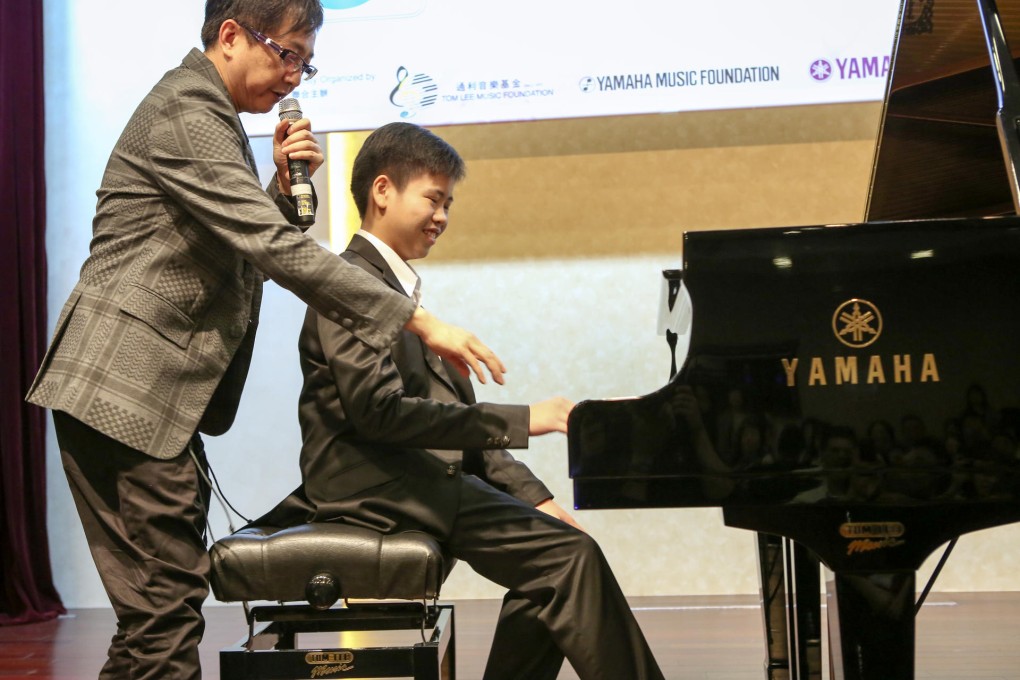 Singer-songwriter Anthony Lun guides 12-year-old composer Anson Wong.