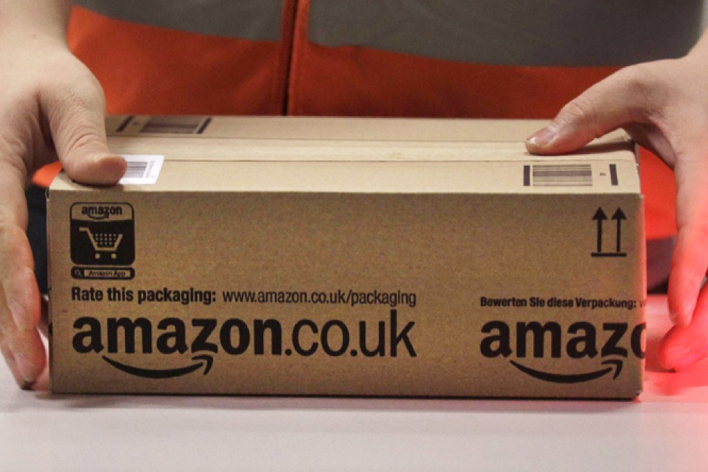 An Amazon worker handles an item for delivery. The company plans to use mini-drones to deliver small packages to customers. Photo: Reuters