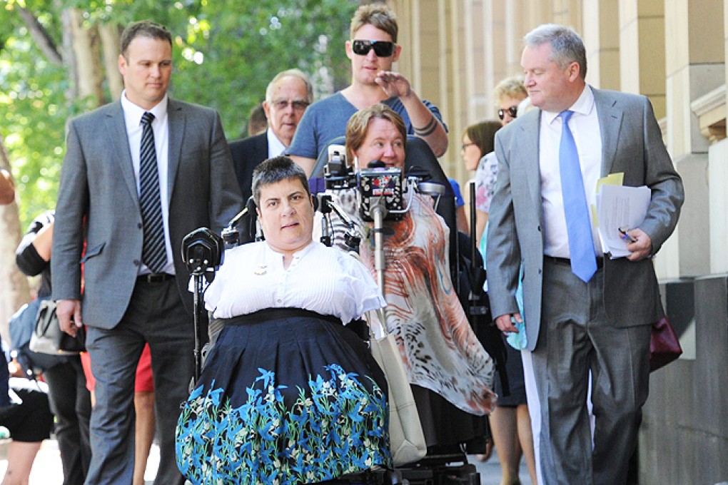 Thalidomide survivors Lynette Rowe (front) and Monica McGhie followed by lawyers and family leave the Supreme Court in Melbourne, Australia, on Monday. Photo: EPA