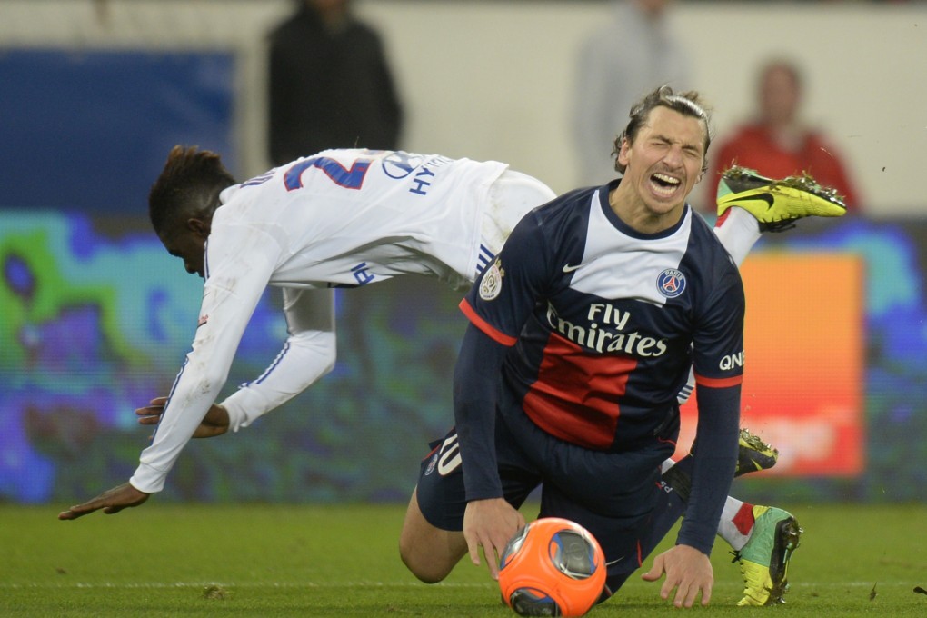 Zlatan Ibrahimovic feels the pain after being tackled by a Lyon defender during Paris Saint-Germain's 4-0 victory. Photo: AFP