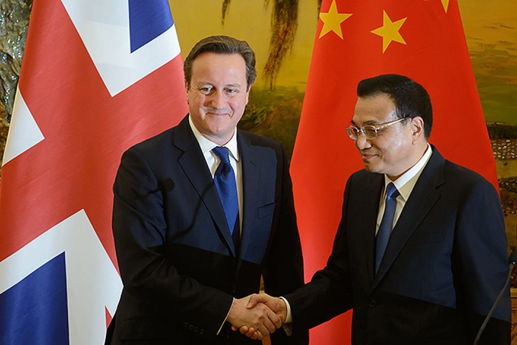 Britain's Prime Minister David Cameron and China's Premier Li Keqiang shake hands at a signing ceremony at the Great Hall of the People in Beijing. Photo: EPA