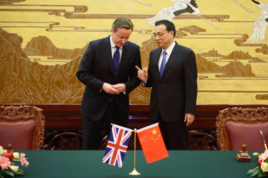 David Cameron and Li Keqiang have a private word as they arrive for a deal-signing ceremony at the Great Hall of the People. Photo: EPA