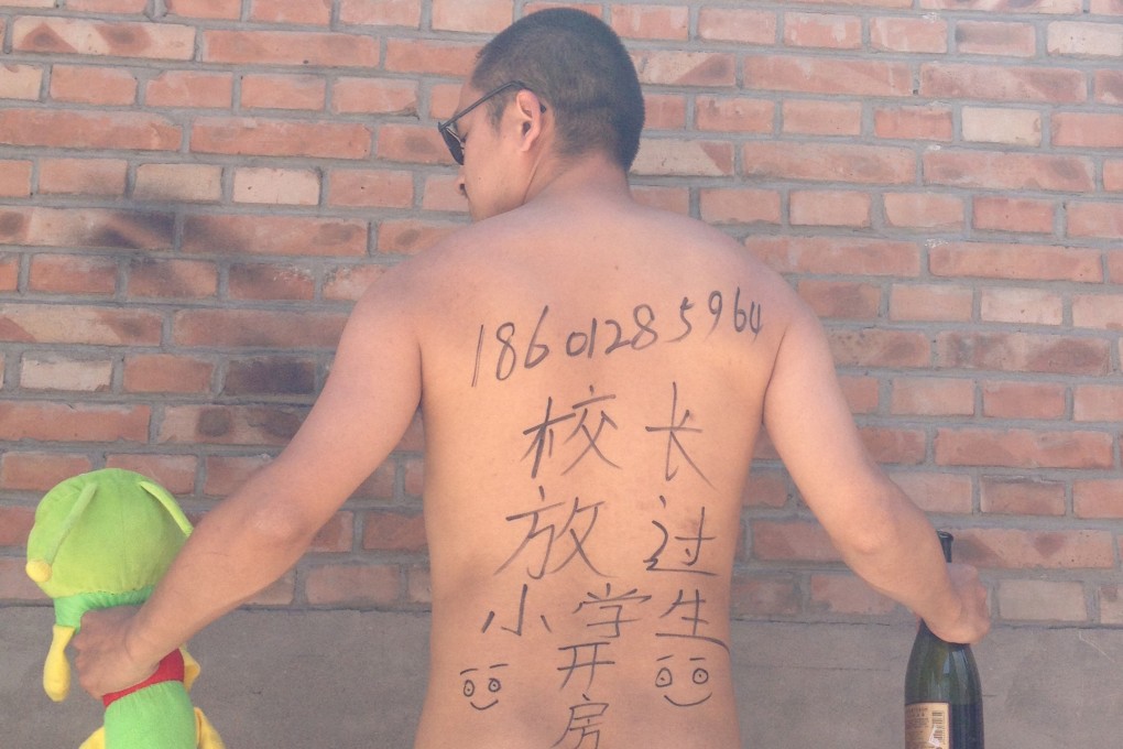 Beijing-based poet Wang Zang protests against the recent spate of child sex abuse cases. Photo: AP