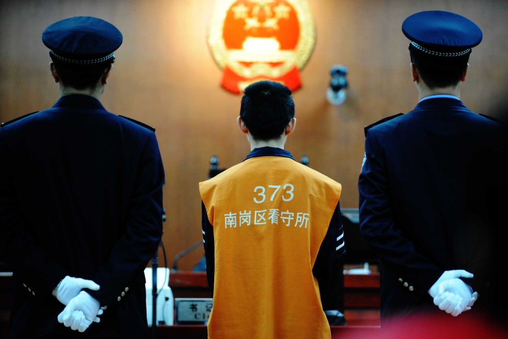 A defendant on trial at the Intermediate People's Court of Harbin, Heilongjiang Province. Courts in Henan province want to abolish the protocol of forcing defendants to wear prison suits and have their heads shaved. Photo: Xinhua