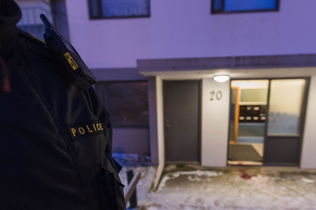 A police officer stands guard at a house where a man was shot dead by poilce in Reykjaiík. Photo: AFP