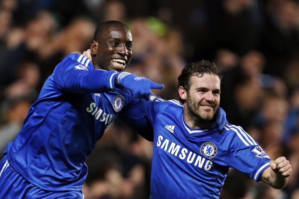 Demba Ba celebrates with Juan Mata after scoring his first Premier League goal of the season on Sunday. Photo: AP