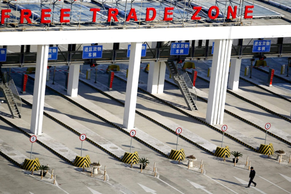 A man walks in front of the entrance of the Shanghai Pilot Free Trade Zone at the Pudong international airport in Shanghai. Photo: Reuters