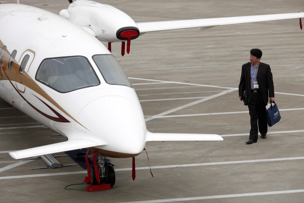 A visitor walks next to a Piaggio Avanti II business aircraft during the Shanghai International Business Aviation Show. Photo: Reuters