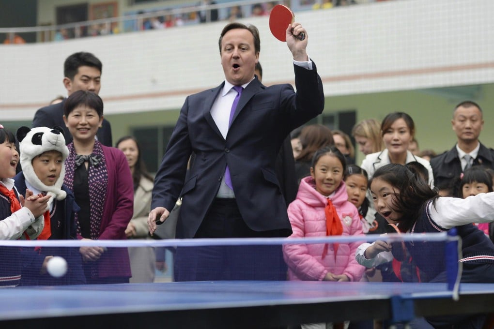 British Prime Minister David Cameron plays table tennis with children in Chengdu. Photo: Reuters