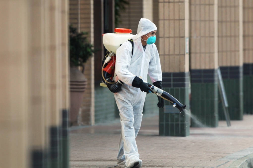 Staffs of Palatiat Coast in Tuen Mun sterilise the area as an Indonesian domestic worker in the housing estate is in a critical condition after confirmed as the first case of H7N9 bird flu in Hong Kong.