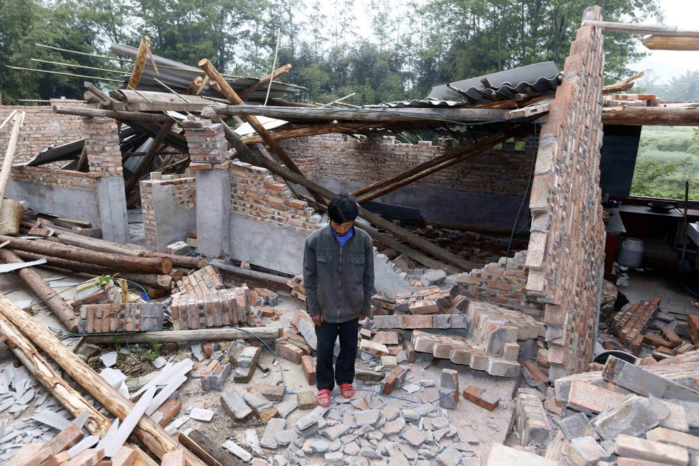 A local resident stands among the Yaan earthquake ruins in southwest China's Sichuan province. Photo: AFP