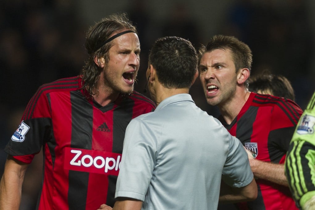 West Bromwich Albion's Gareth McAuley (left) and Jonas Olsson protest against a Chelsea penalty given by referee Andre Marriner (centre) at Stamford Bridge stadium on November 9. Photo: AP