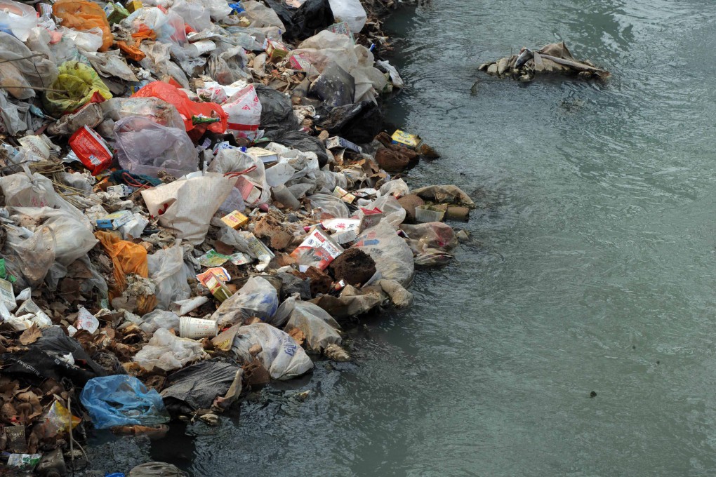 Rubbish in a polluted canal on the edge of Beijing. Filmmaker Wang Jiuliang visited more than 500 landfills to document the effect of China's spiralling consumption. Photo: AFP