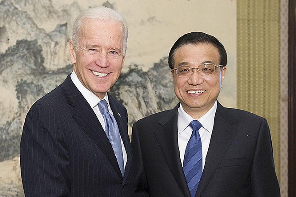 Smiles all around: Joe Biden shakes hands with Li Keqiangin Beijing. Photo: Xinhua