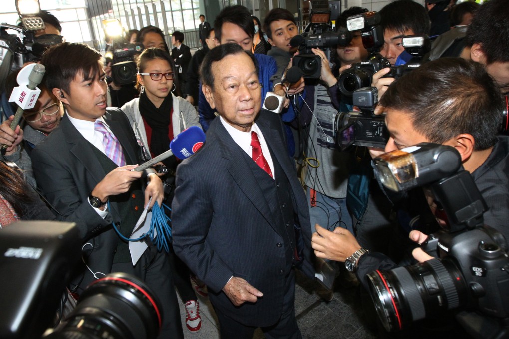 Heung Yee Kuk lawmaker Lau Wong-fat is surrounded by reporters as he attends a Legislative Council meeting. Photo: Felix Wong