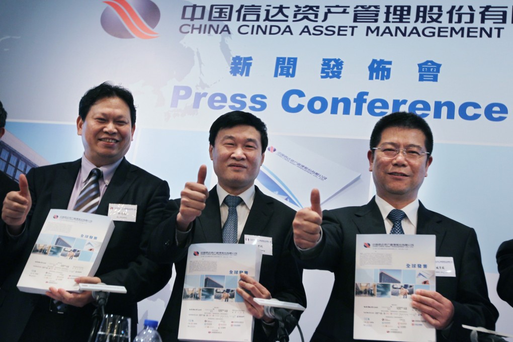 Cinda Asset executives Xu Zhichao, Hou Jianhang, and Zang Jingfan at the IPO launch. Photo: Nora Tam