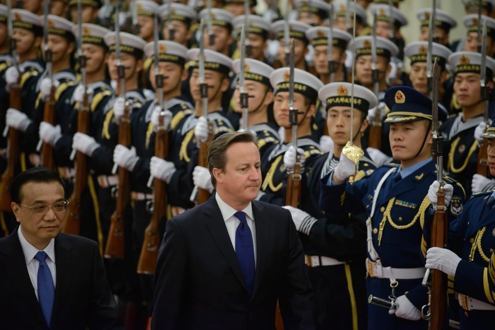 Britain's Prime Minister David Cameron and China's Premier Li Keqiang inspect and honour guard at the Great Hall of the People in Beijing on Tuesday. Photo: EPA