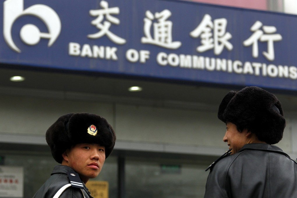 Security guards outside a branch of the Bank of Communications in central Beijing. Reuters