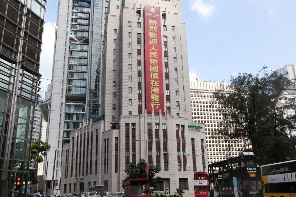 A signboard celebrating the issuance of yuan-denominated sovereign bonds in Hong Kong is seen outside the Bank of China Building.