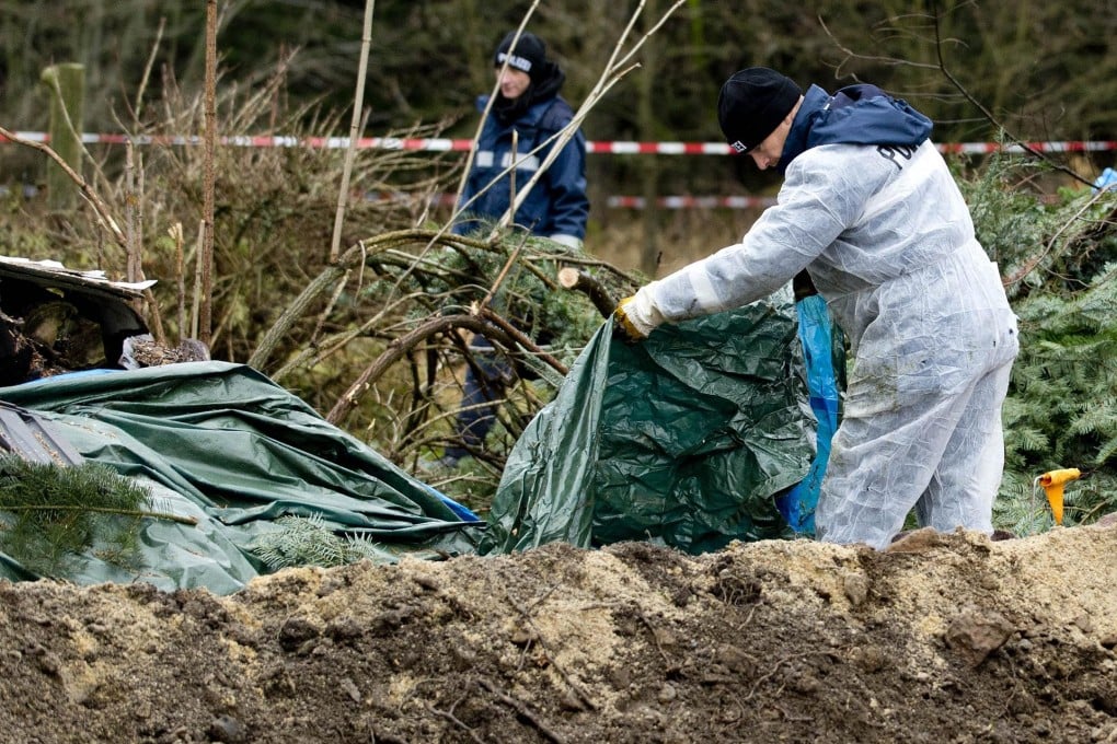 Policemen search for parts of the body of victim Wojciech S last month. Photo: AFP
