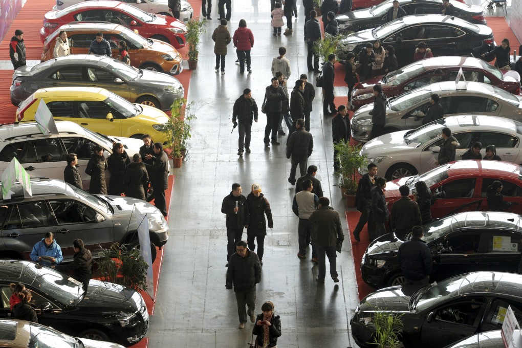 Visitors look at cars at an auto sales event in Nanjing, in eastern China's Jiangsu province. Photo: AP