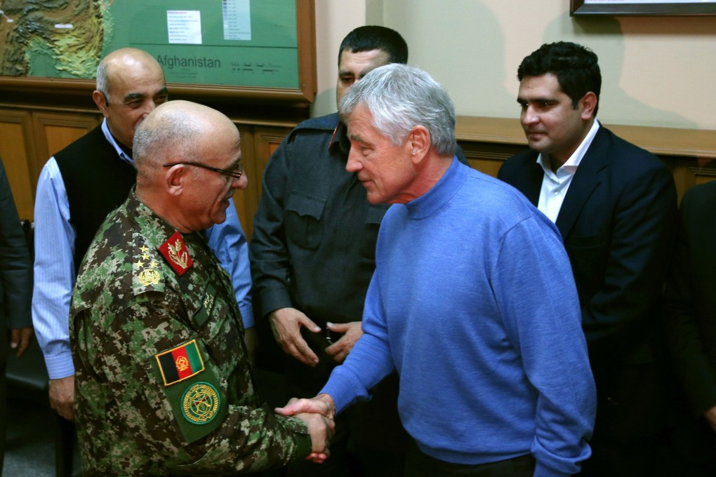 US Secretary of Defence Chuck Hagel and Afghan General Sher Mohammad Karimi. Photo: AFP