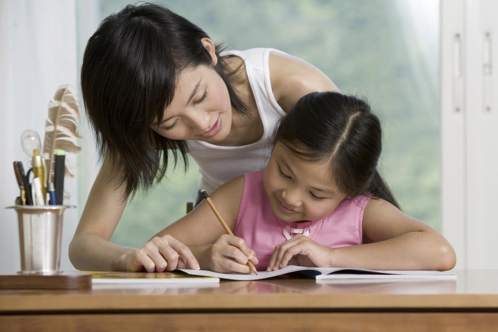 A mother helps out with homework.