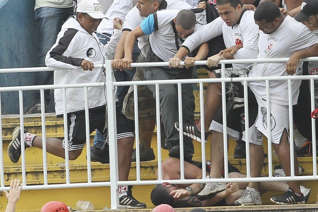 Vasco da Gama fans beat up an Atletico Paranaense supporter during their first division league match in Joinville, Santa Catarina state. The game was halted for an hour when security had to intervene. Photo: Reuters